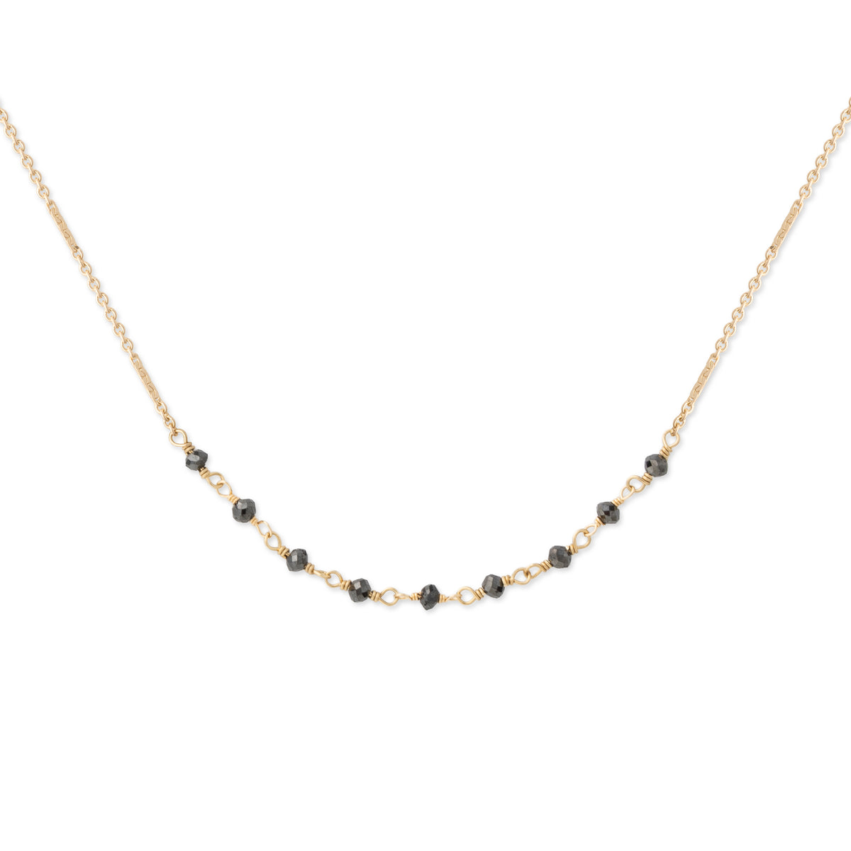 A delicate gold chain necklace featuring a curved line of small, faceted black beads separated by tiny gold links, displayed against a solid white background.