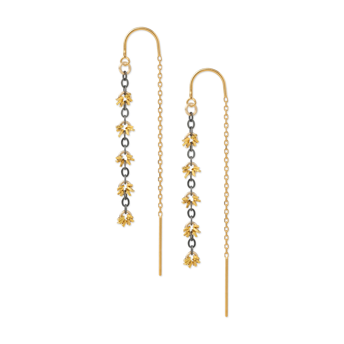 A pair of gold dangle earrings with floral motifs, featuring yellow-gold flower charms, dark metallic spacer rings, and a fine gold chain leading to a long straight drop.