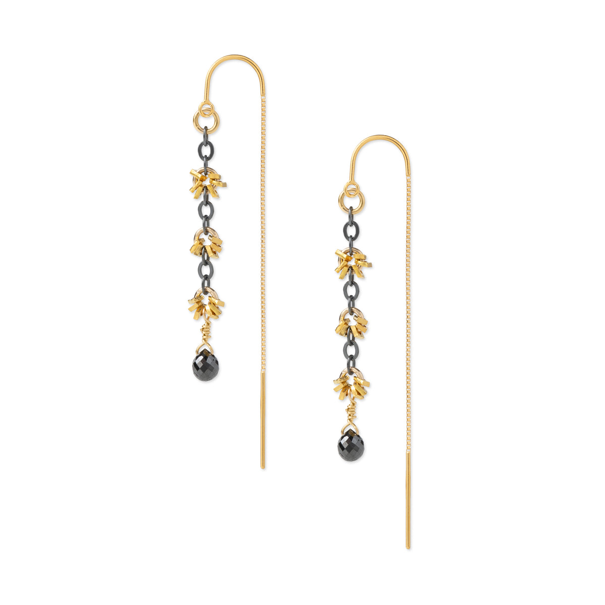 A pair of gold and black drop earrings with floral details and teardrop charms, shown on a plain white background.