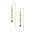 A pair of gold and black drop earrings with floral details and teardrop charms, shown on a plain white background.