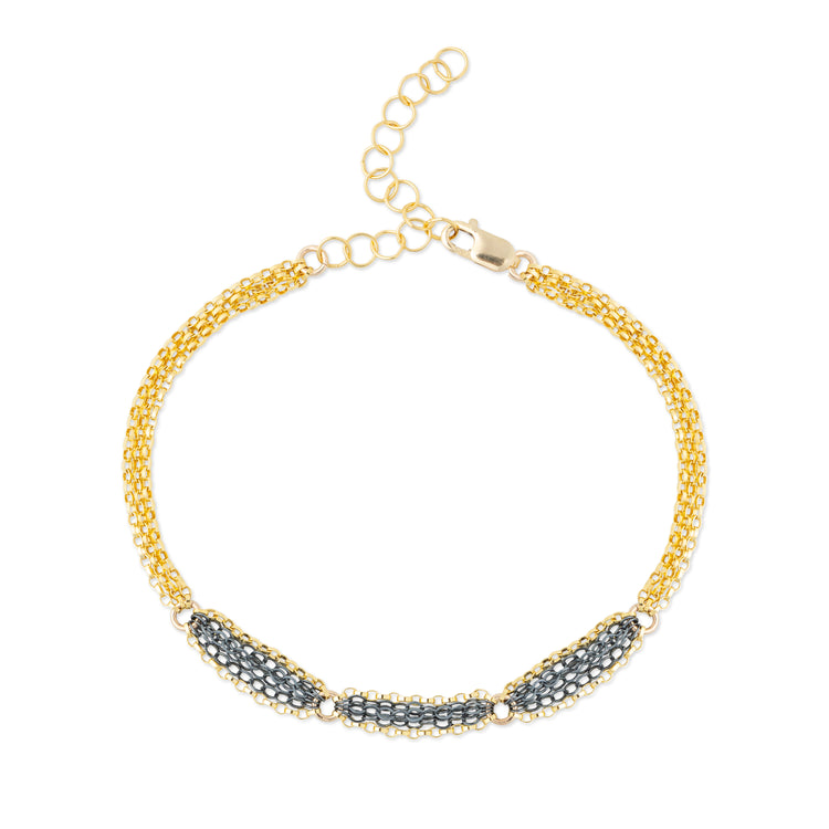 A mixed metal bracelet with a patterned chain of 14K gold-fill and oxidized sterling silver, displayed on a white background.