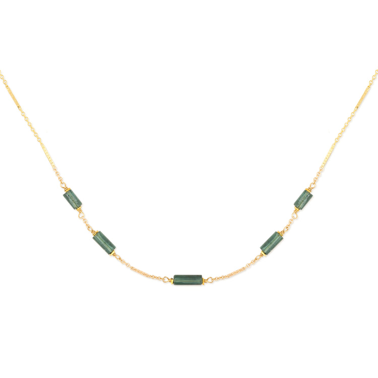 Necklace with teal tourmaline beads on a gold chain against a white background