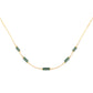 Necklace with teal tourmaline beads on a gold chain against a white background