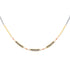 Mixed metal necklace with natural faceted garnets on a white background