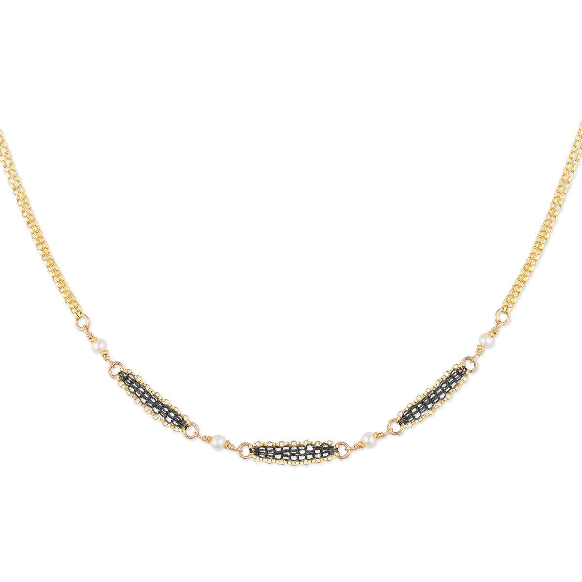 Gold necklace with black and white bead details on a white background
