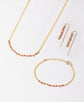 Coral and gold necklace, threaders and bracelet on a white background 