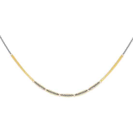 A double-stranded mixed metal necklace with a combination of gold-fill and oxidized sterling silver showcasing a patterned chain design.