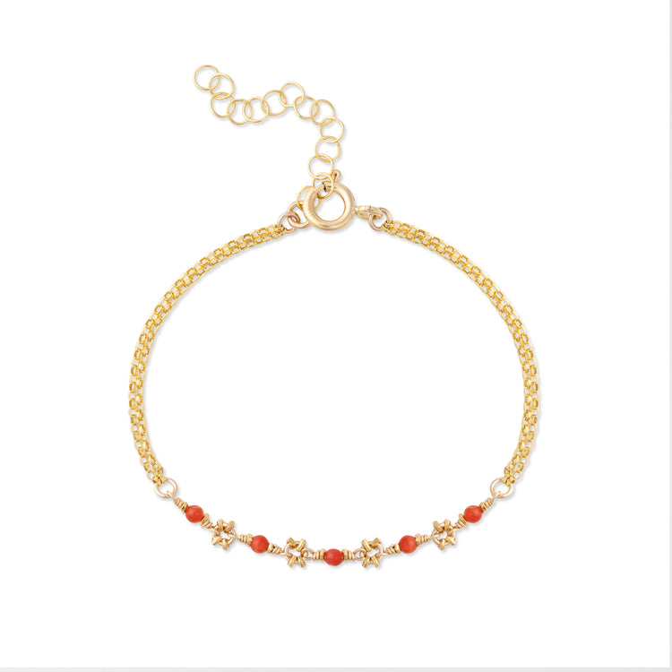 A gold-colored bracelet featuring small red coral beads and gold accents, with a chain clasp.