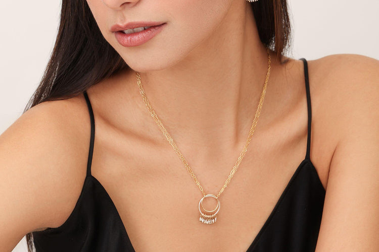 A modern woman wearing classic 14K gold-fill double circle fringe necklace featuring double stranded chain. 