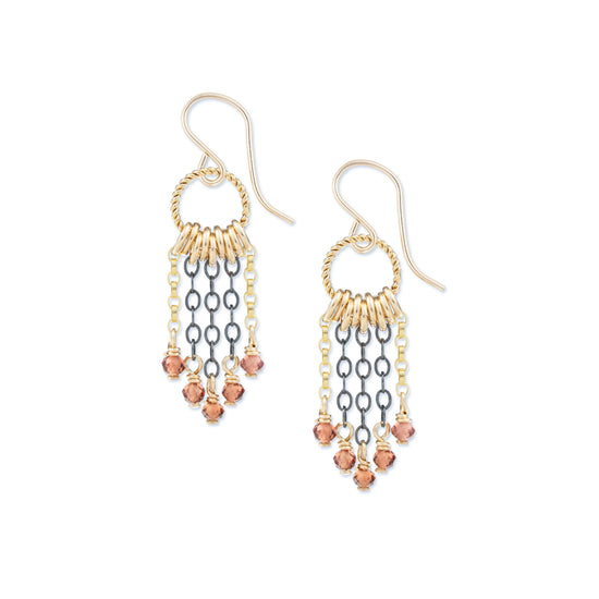 Pair of gold and oxidized silver beaded red garnet earrings on a white background