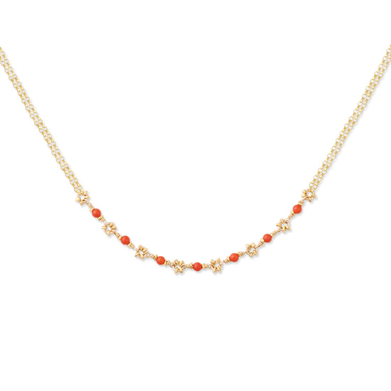 A double-stranded necklace with gold accents and red coral beads, displayed against a white background.