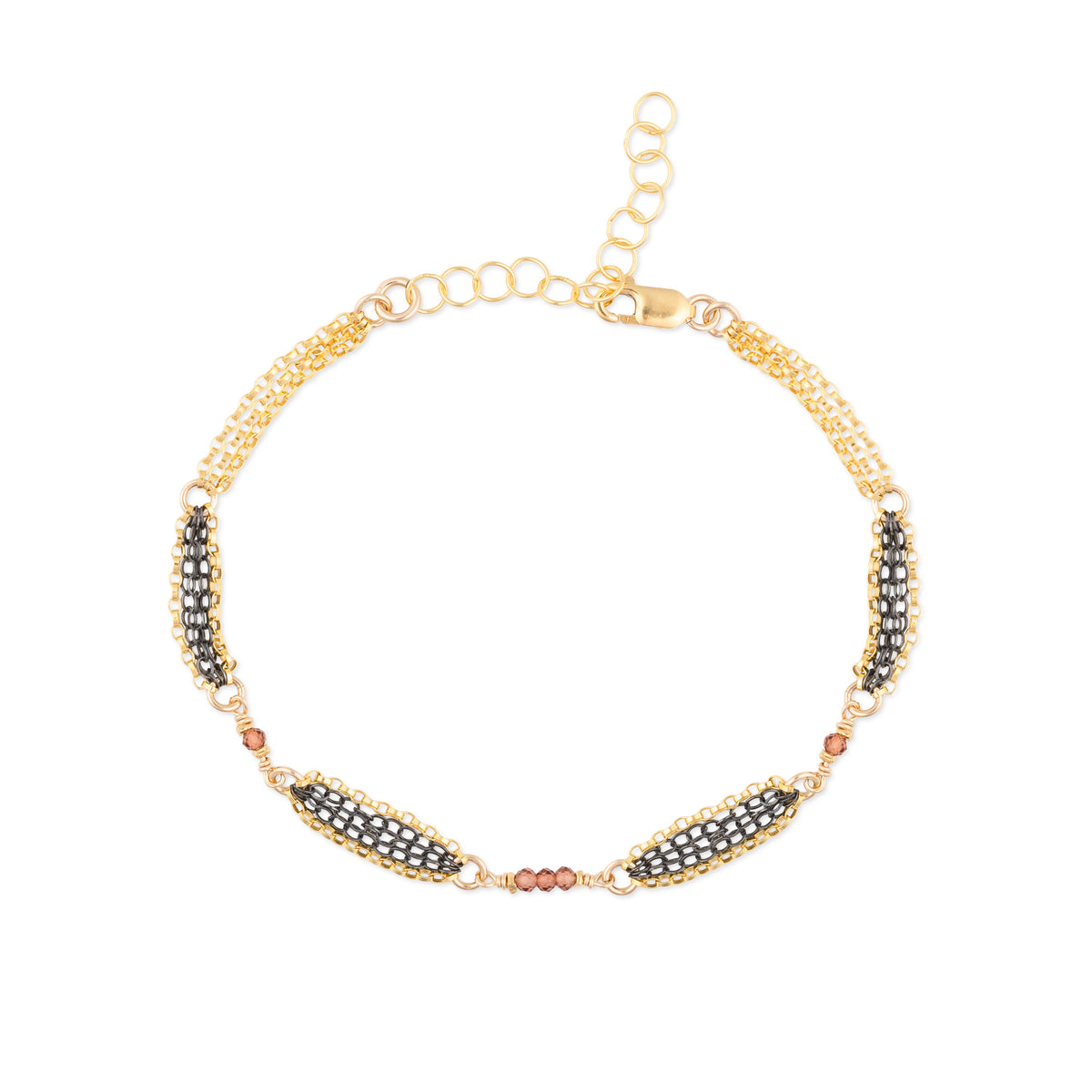 Gold bracelet with oxidized chain details and red garnet  beads on a white background