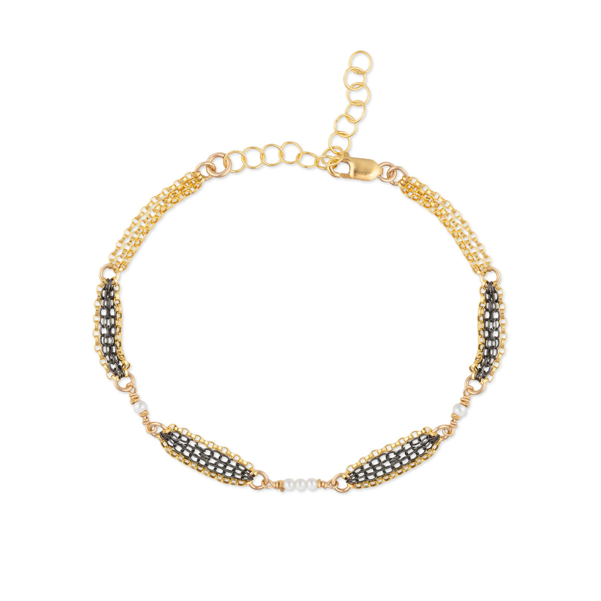 Gold bracelet with oxidized sterling silver chain and pearls on a white background
