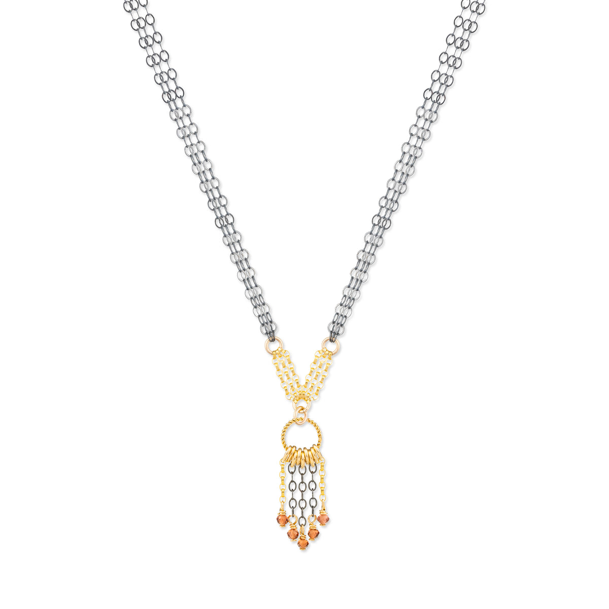 Necklace with a gold and oxidized silver pendant with garnet stones on a white background