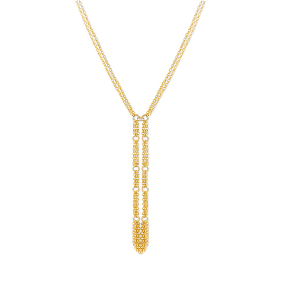 A gold Y-necklace featuring a long, vertical dangle pendant adorned with small, textured gold details, set against a plain white background.