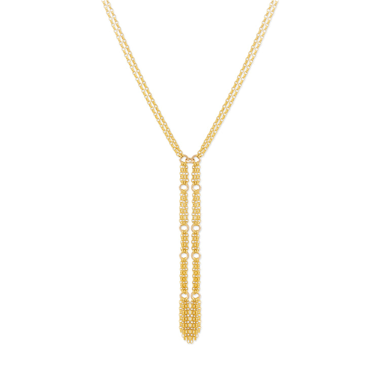 A gold Y-necklace featuring a long, vertical dangle pendant adorned with small, textured gold details, set against a plain white background.