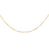 A delicate gold chain necklace with alternating textured oval links and small round clear stones, displayed in a curved shape against a plain white background.
