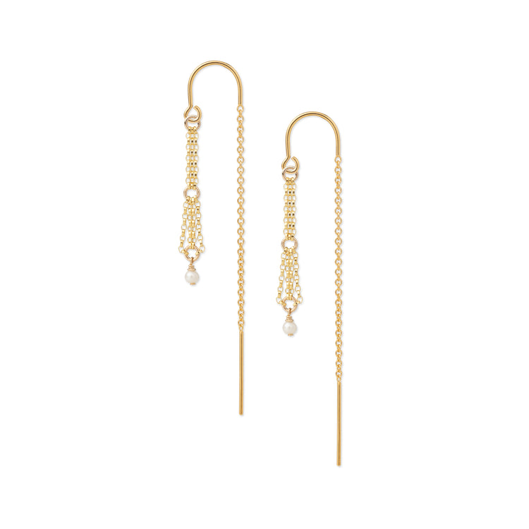 A pair of gold drop earrings with delicate chain drapes and small white pearl accents, shown against a plain white background.
