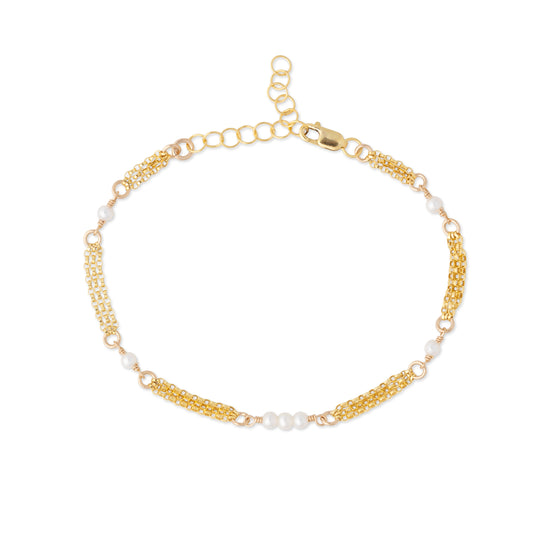 A delicate gold chain anklet featuring alternating small white pearl beads and textured gold spacer links, displayed on a clean white background.