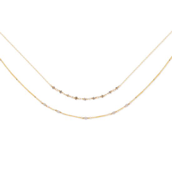 A double-stranded necklace with faceted gray diamonds set on two chains, with a 14K gold fill. The shorter chain is 16 inches, and the longer chain includes an 18-inch base with an additional 2-inch extender.