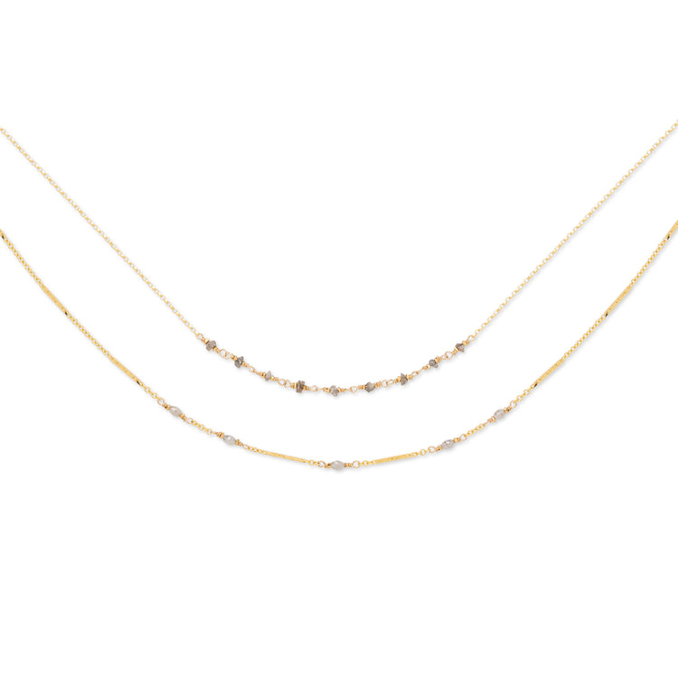 A double-stranded necklace with faceted gray diamonds set on two chains, with a 14K gold fill. The shorter chain is 16 inches, and the longer chain includes an 18-inch base with an additional 2-inch extender.