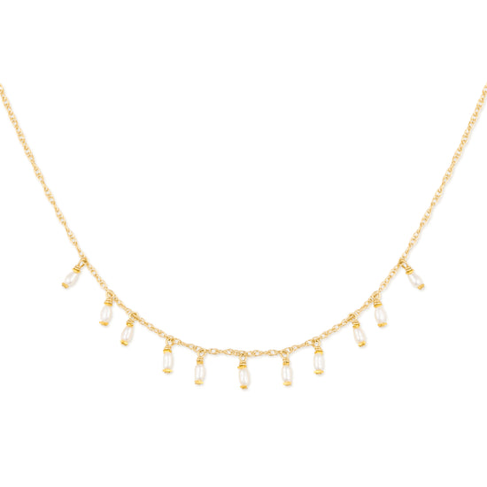Gold necklace with teardrop-shaped pearls on a white background