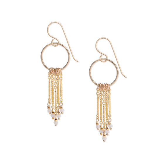 Intricately patterned gold chain fringe earrings embellished with faceted white sapphire gemstones, shown on a white background.